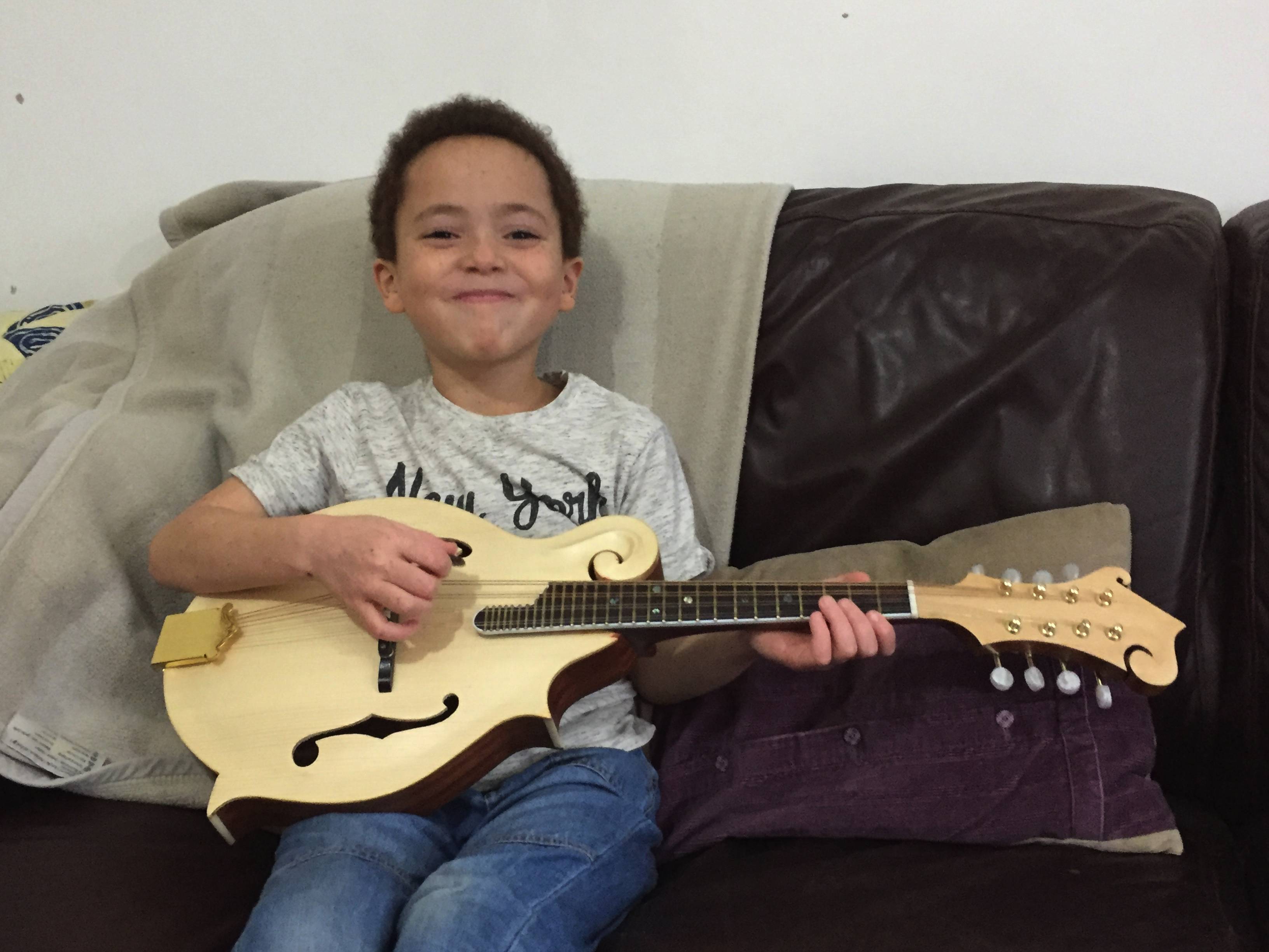 My Grandson Milo with his new mandolin